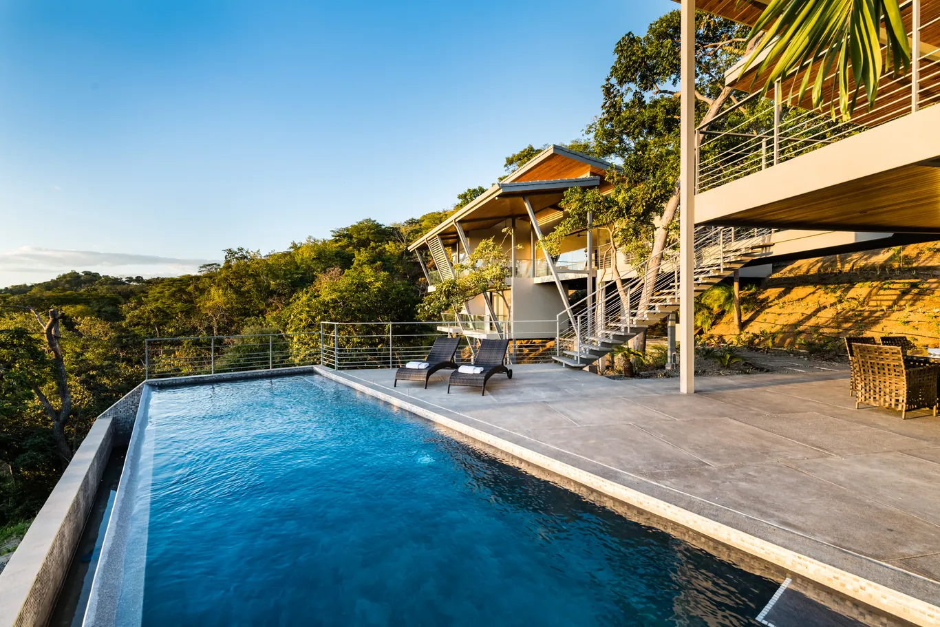 House raised on slender columns above the pool terrace