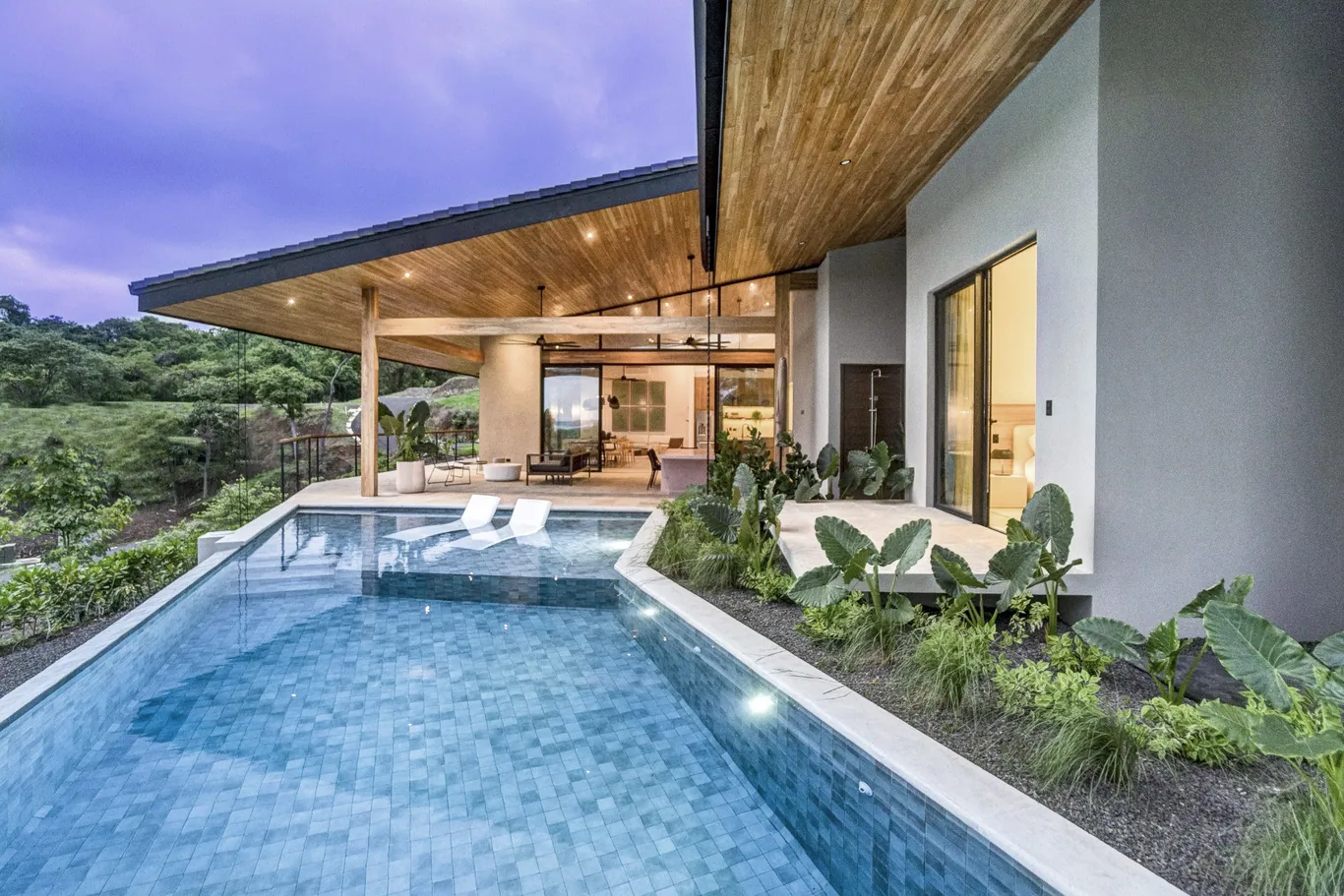 Wood-lined eaves and rendered walls beside the pool